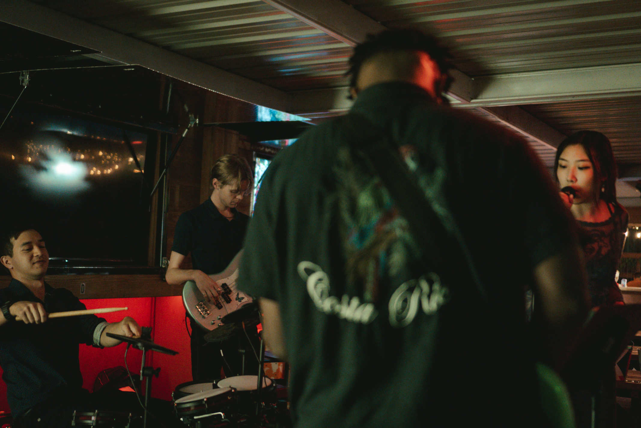 Band performing with sports on TV in background