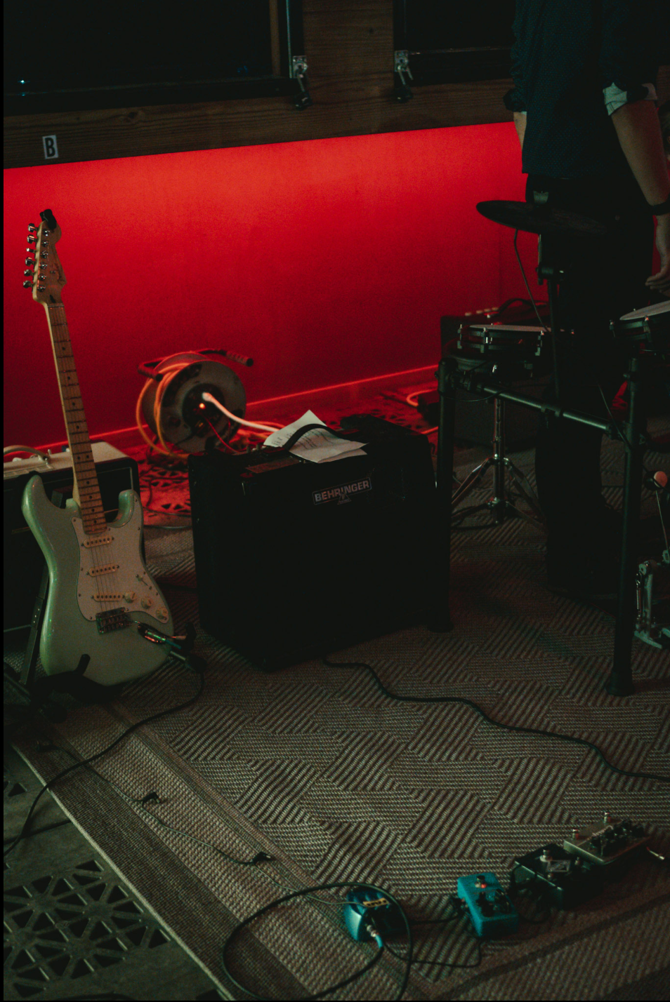 Guitar and pedals on stage floor