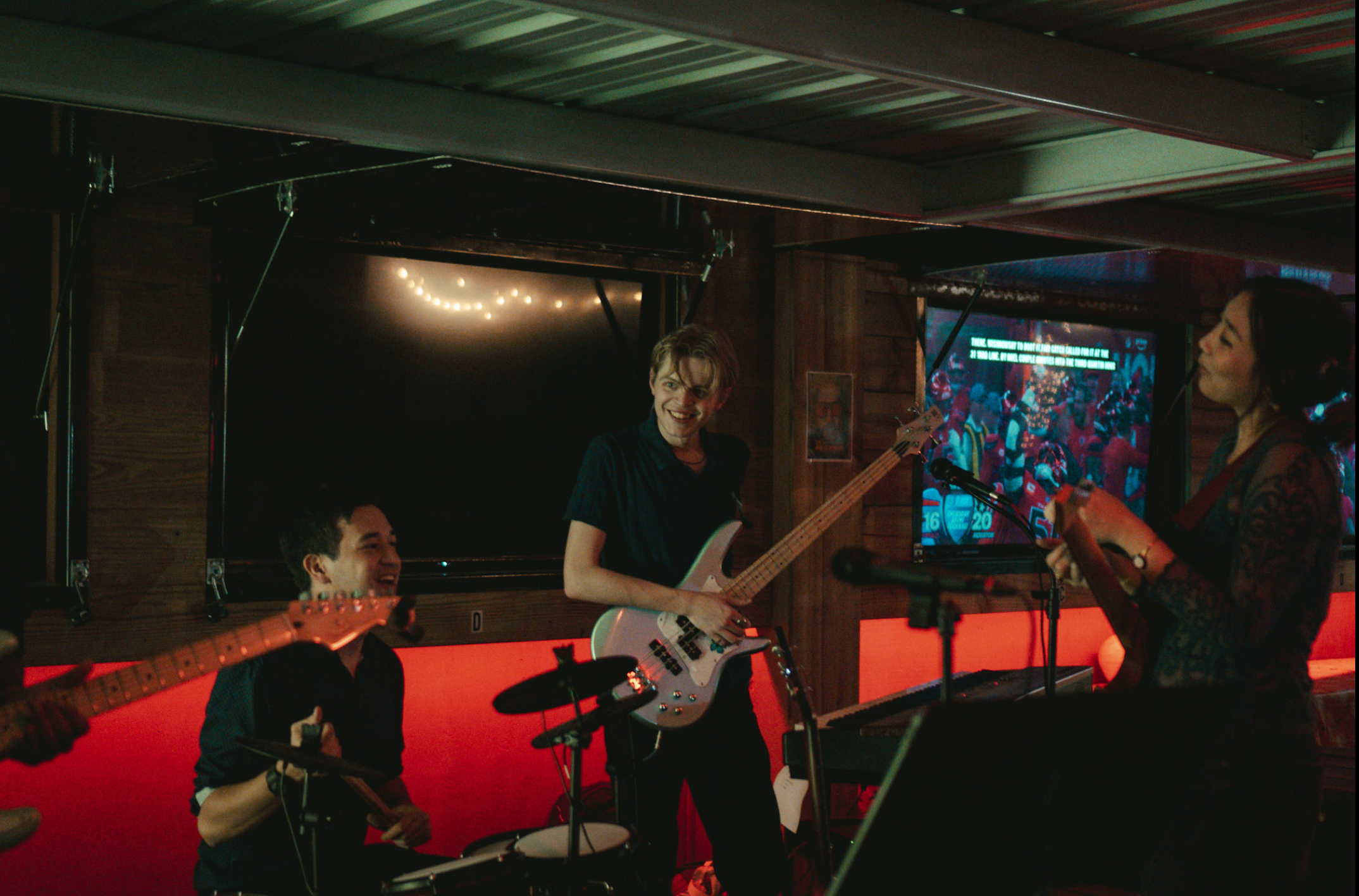 Full band shot with bass player center stage