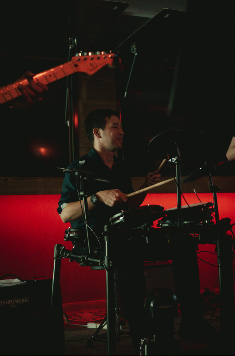 Drummer in action under stage lights